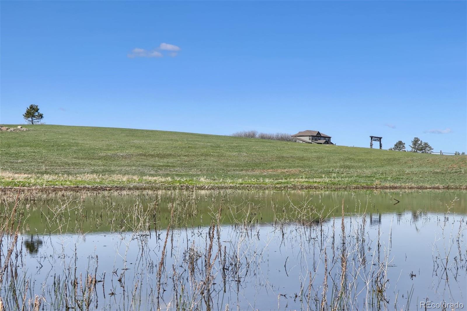 2940 Canon Ridge Road Castle Rock, CO 80104 - Photo 10 of 49 a view of a lake with a house in the background