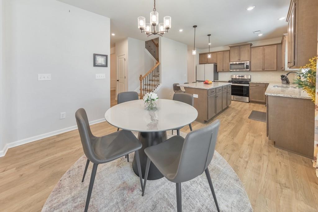 3146 Dowsing Lane Powder Springs, GA 30127 - Photo 12 of 42 a view of a dining room with furniture and wooden floor