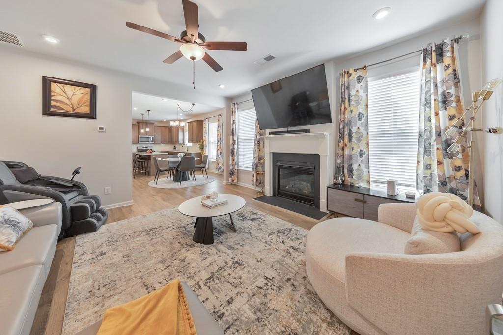 3146 Dowsing Lane Powder Springs, GA 30127 - Photo 15 of 42 a living room with furniture a fireplace and a flat screen tv