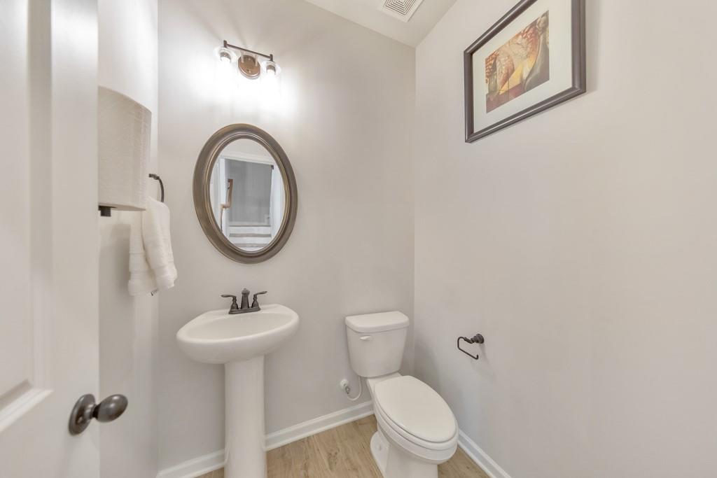 3146 Dowsing Lane Powder Springs, GA 30127 - Photo 16 of 42 a bathroom with a toilet sink and mirror