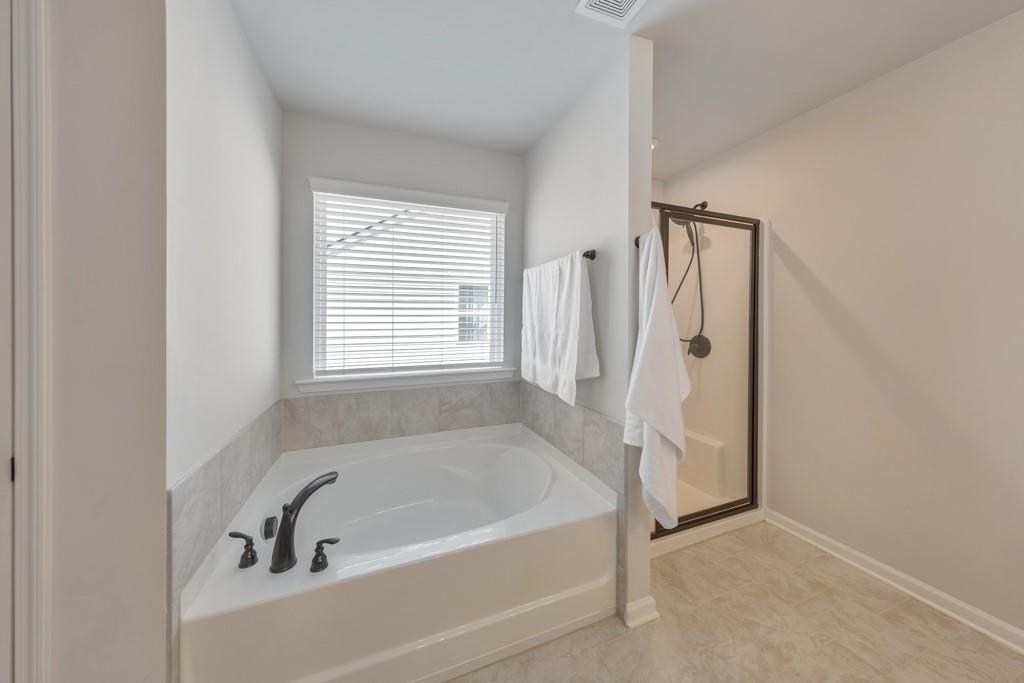 3146 Dowsing Lane Powder Springs, GA 30127 - Photo 22 of 42 a white bath tub sitting next to a window