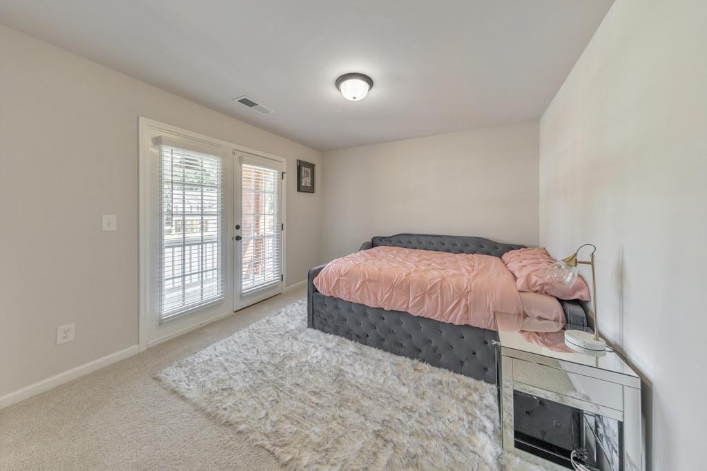 3146 Dowsing Lane Powder Springs, GA 30127 - Photo 24 of 42 a bedroom with a bed and wooden floor