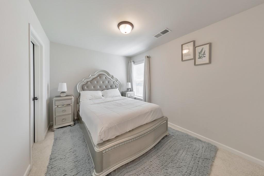 3146 Dowsing Lane Powder Springs, GA 30127 - Photo 27 of 42 a bedroom with a bed and cabinets