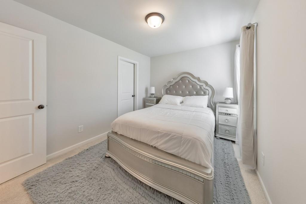 3146 Dowsing Lane Powder Springs, GA 30127 - Photo 28 of 42 a bedroom with a bed and a rug