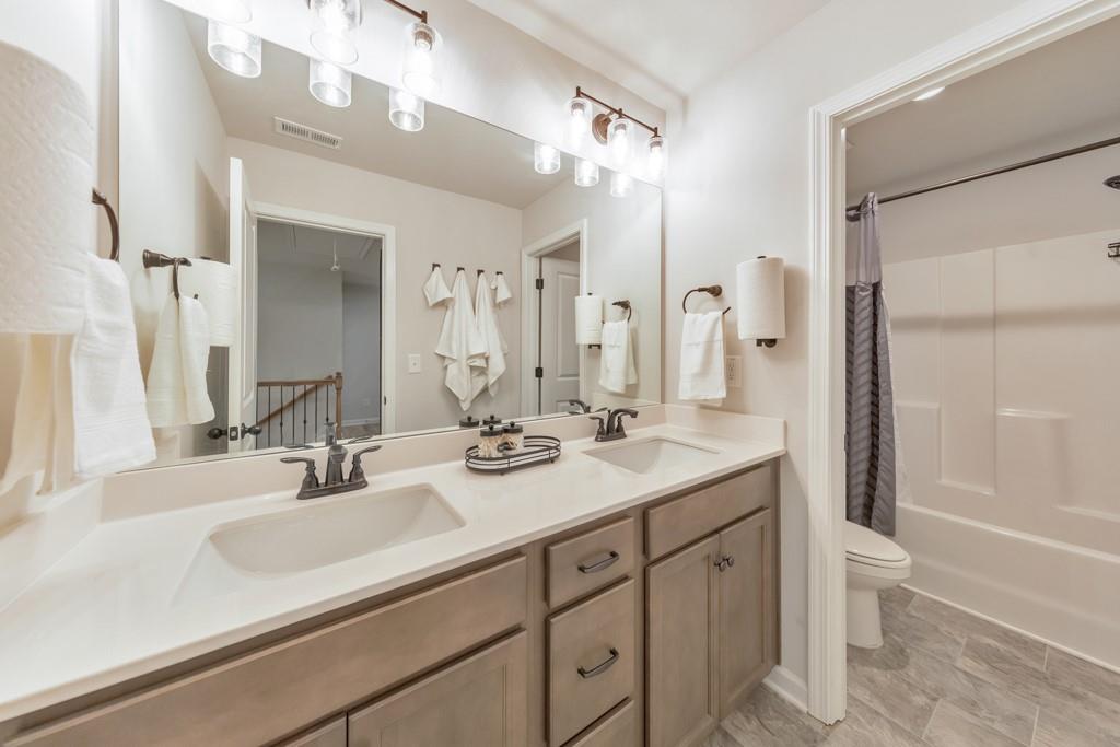 3146 Dowsing Lane Powder Springs, GA 30127 - Photo 29 of 42 a bathroom with a sink double vanity granite tub and a mirror