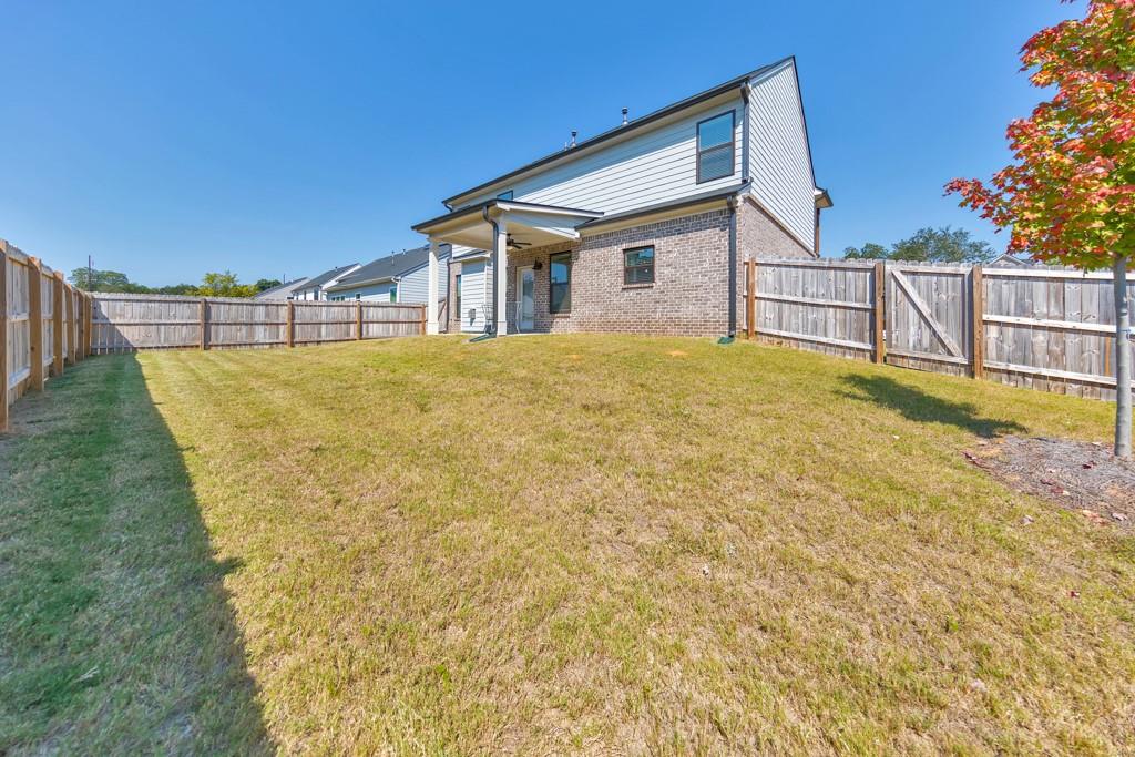 3146 Dowsing Lane Powder Springs, GA 30127 - Photo 33 of 42 a view of a house with backyard and trees