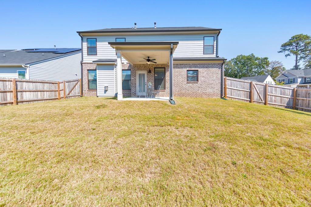 3146 Dowsing Lane Powder Springs, GA 30127 - Photo 34 of 42 a view of a house with floor to ceiling windows and a basket ball poll