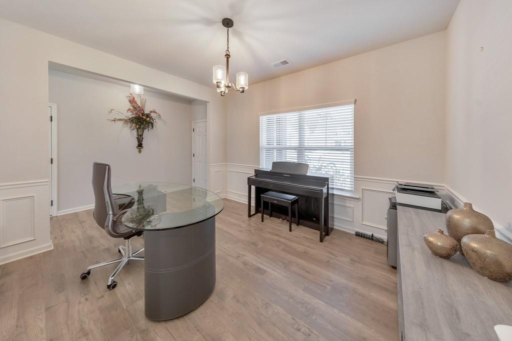 3146 Dowsing Lane Powder Springs, GA 30127 - Photo 6 of 42 a living room with furniture a piano and a chandelier