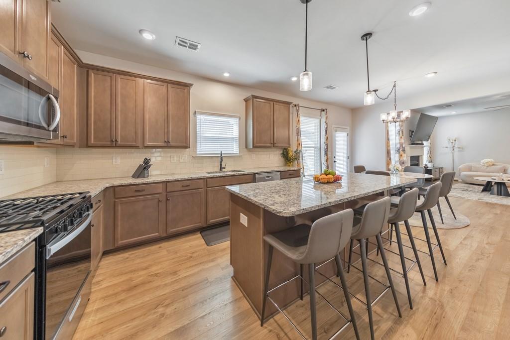 3146 Dowsing Lane Powder Springs, GA 30127 - Photo 9 of 42 a kitchen with granite countertop a sink a counter top space appliances and cabinets