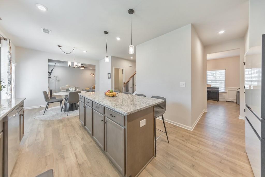 3146 Dowsing Lane Powder Springs, GA 30127 - Photo 10 of 42 a kitchen with a stove and a wooden floor