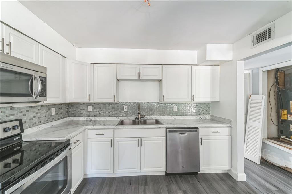 18 Quail Run, Unit A Decatur, GA 30035 - Photo 9 of 28 a kitchen with a sink stove and refrigerator