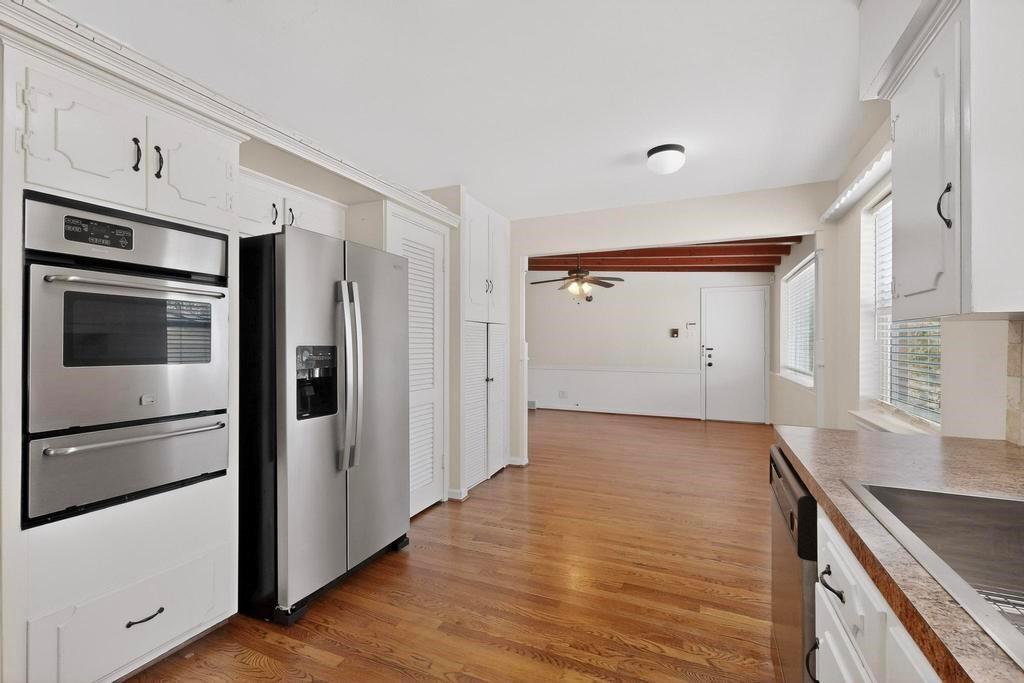 2120 Healey Drive Dallas, TX 75228 - Photo 14 of 39 a view of a kitchen with wooden floor and electronic appliances