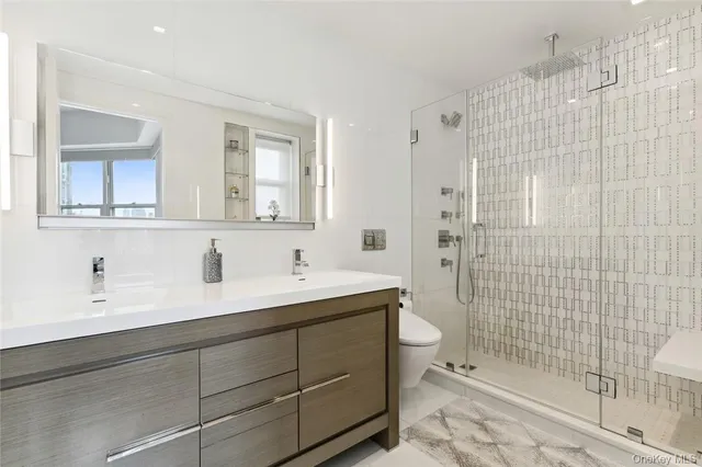 a bathroom with a sink a toilet and shower