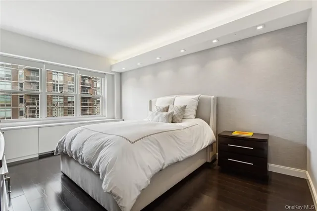 a bedroom with a bed and a large window