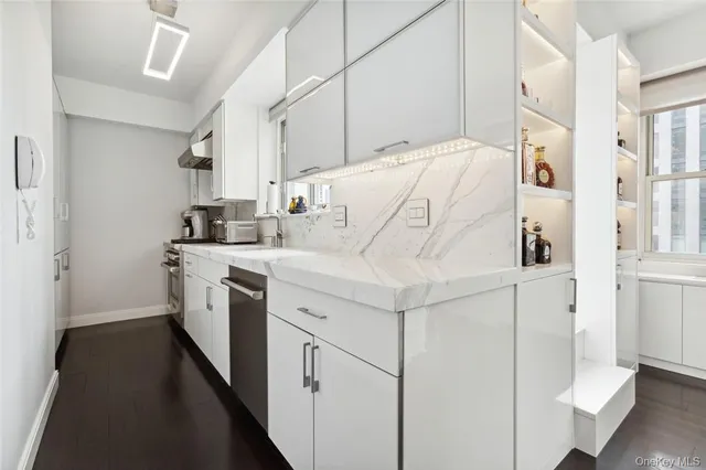 a utility room with cabinets washer and dryer
