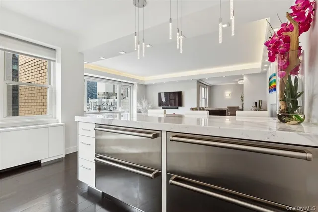a view of a room with kitchen island and stainless steel appliances
