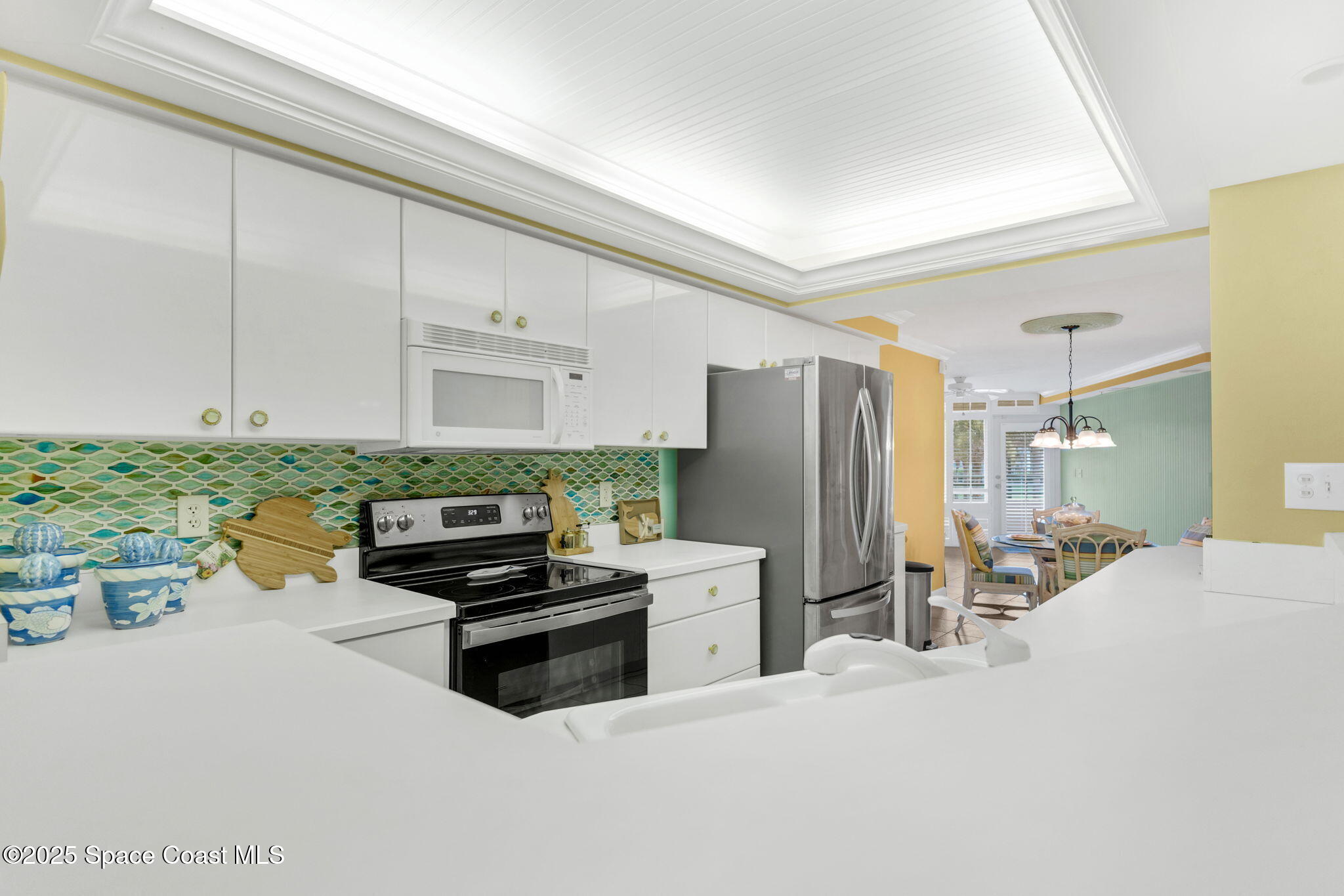 4631 South Atlantic Avenue, Unit 8102 Port Orange, FL 32127 - Photo 17 of 27 a kitchen with stainless steel appliances a refrigerator and a stove top oven