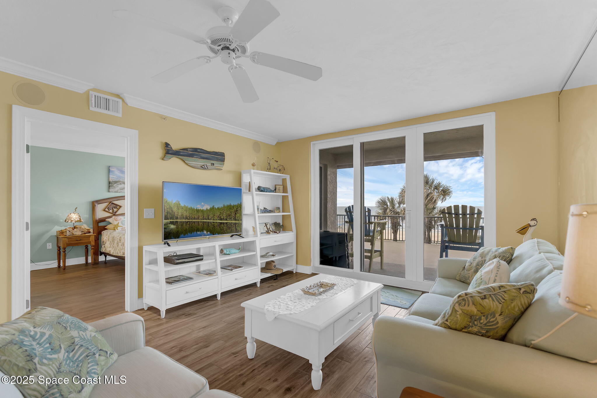 4631 South Atlantic Avenue, Unit 8102 Port Orange, FL 32127 - Photo 18 of 27 a living room with furniture and a flat screen tv