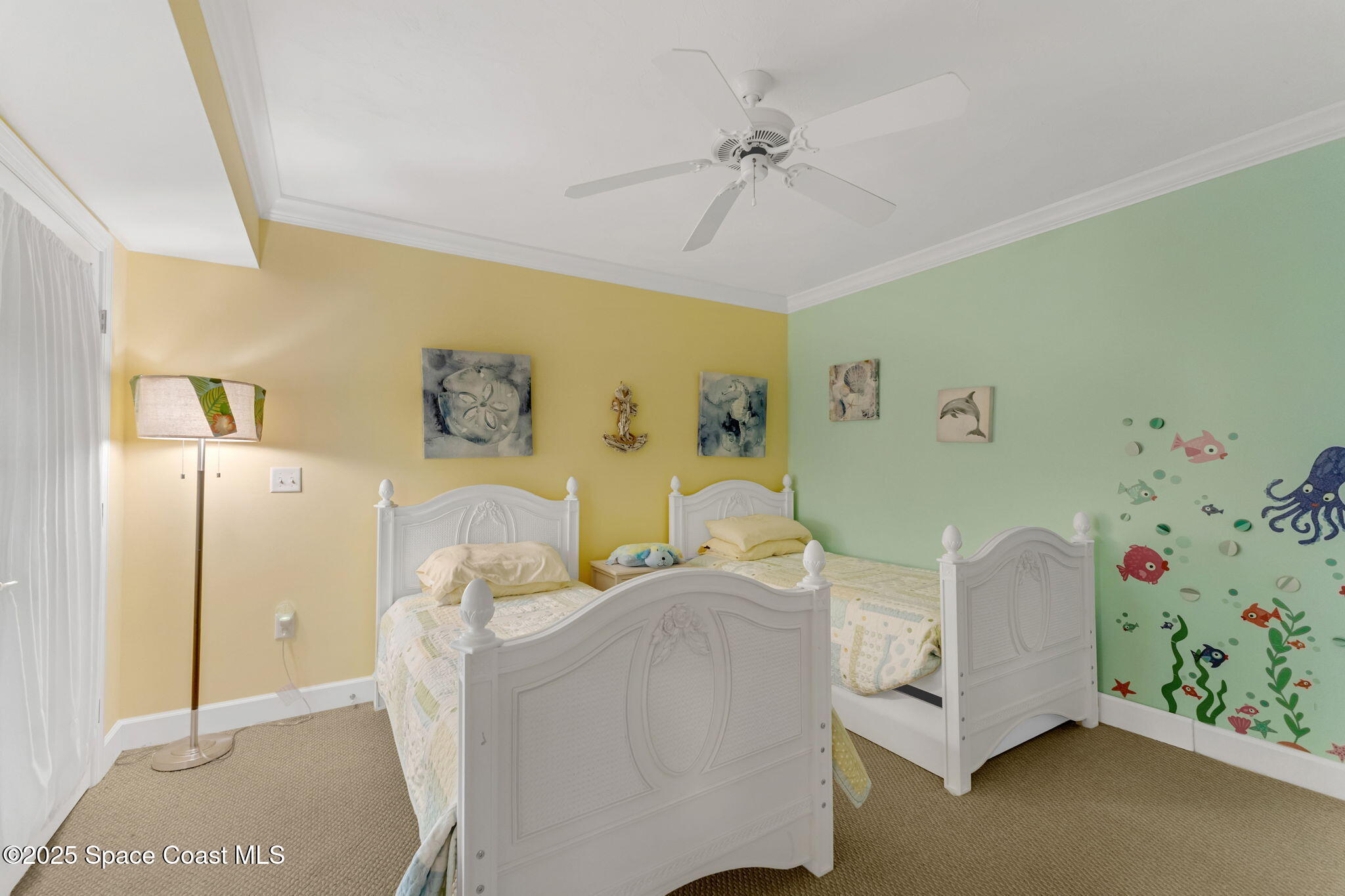 4631 South Atlantic Avenue, Unit 8102 Port Orange, FL 32127 - Photo 22 of 27 a bedroom with a bed and ceiling fan