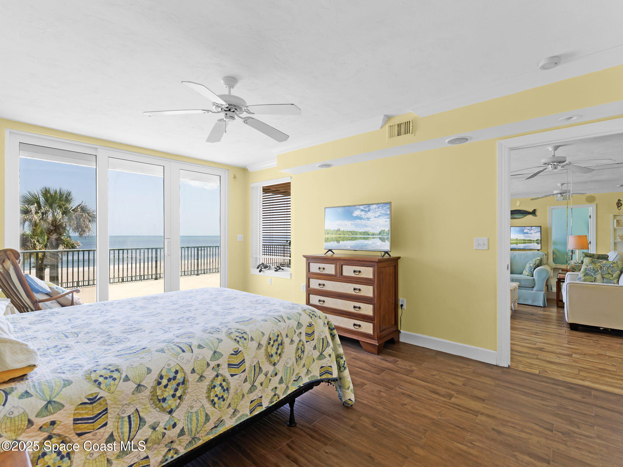 4631 South Atlantic Avenue, Unit 8102 Port Orange, FL 32127 - Photo 7 of 27 a bedroom with a bed and wooden floor