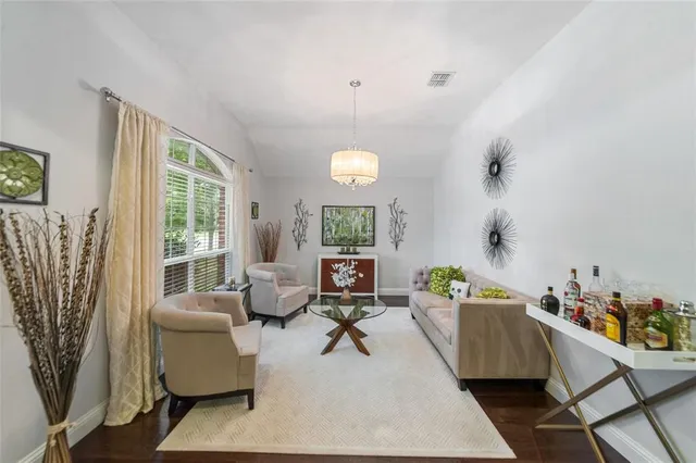 a living room with furniture and a chandelier