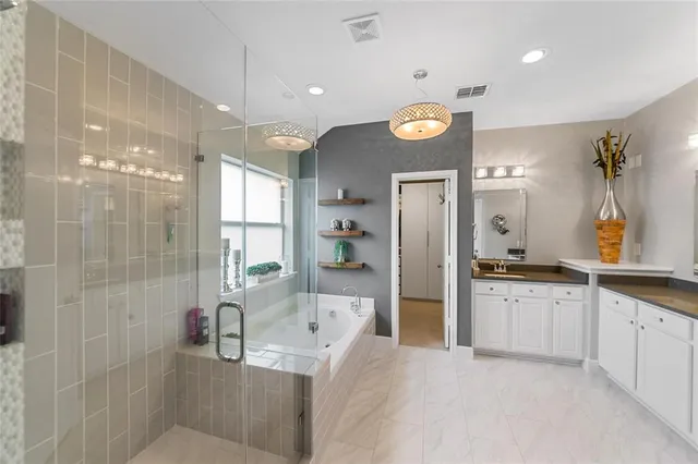 a large bathroom with a large tub shower sink and mirror