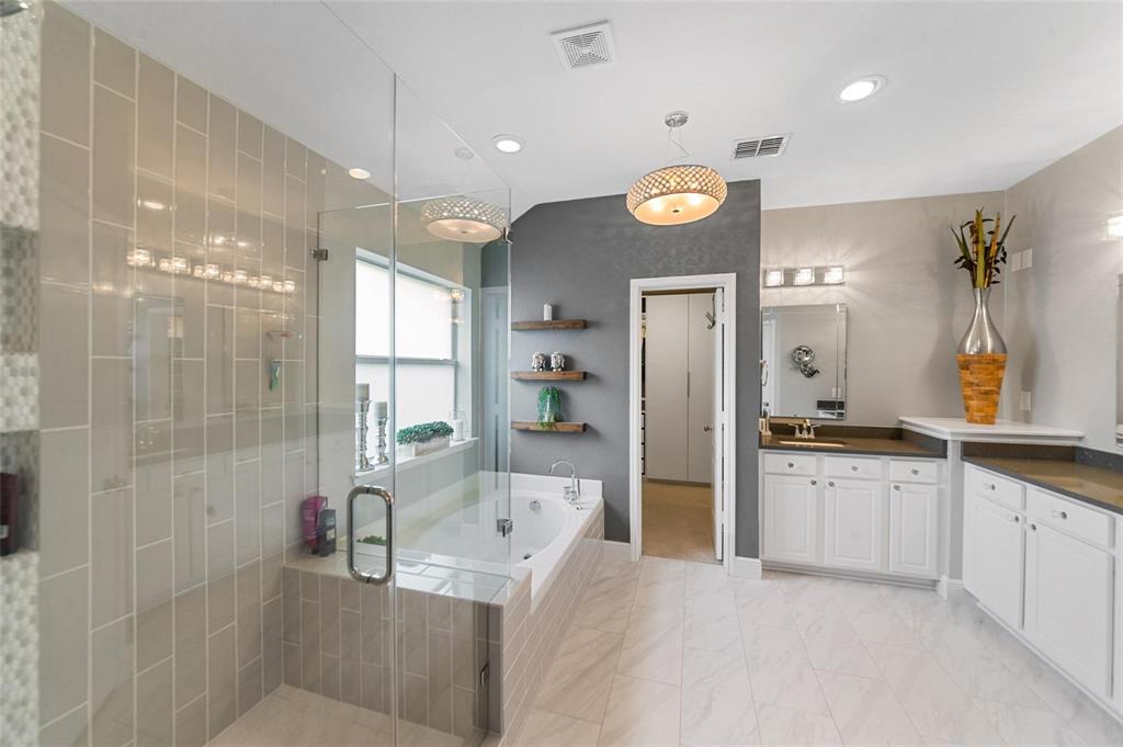 1551 Crystal Pass Allen, TX 75002 - Photo 14 of 27 a large bathroom with a large tub shower sink and mirror