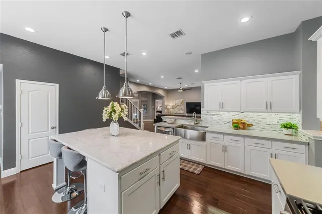 a kitchen with lot of counter space and wooden floor