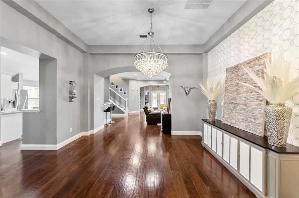 1551 Crystal Pass Allen, TX 75002 - Photo 9 of 27 a view of a hallway with wooden floor windows and a chandelier
