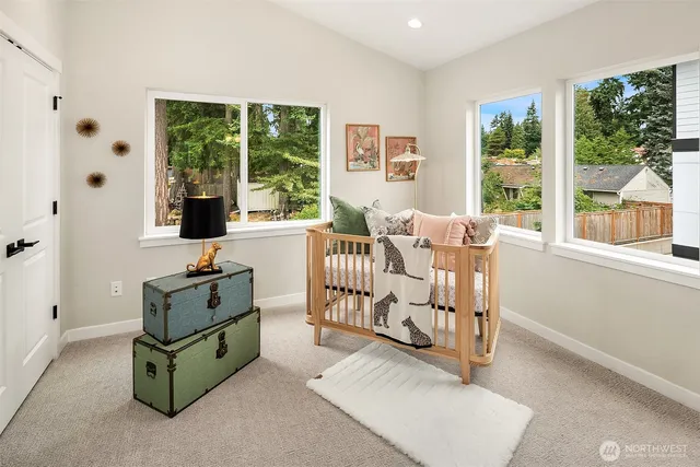 a living room with furniture gym equipment and large windows