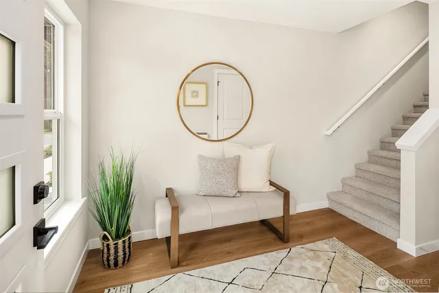 a living room with furniture and a potted plant