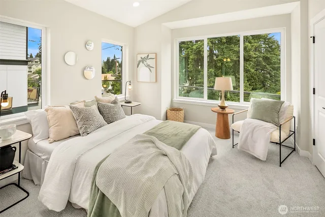 a bedroom with a bed and a large window