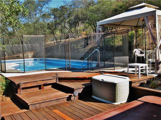 27309 Oakmont Road Valley Center, CA 92082 - Photo 12 of 17 Pool with Security Fence and shaded seating area.