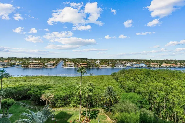 a view of a lake with houses in back