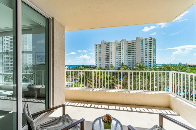 a view of balcony with a large window and wooden floor