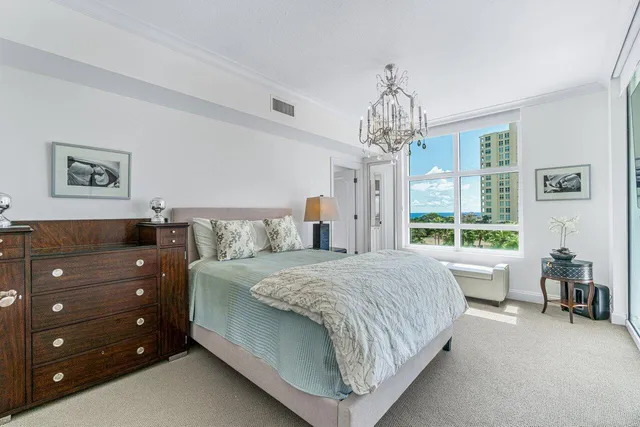 a spacious bedroom with a bed and a flat screen tv