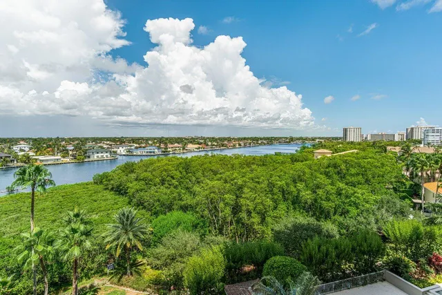 a spacious bedroom with a bed and a flat screen tv
