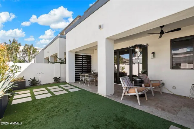 a view of a patio with table and chairs with wooden floor and fence