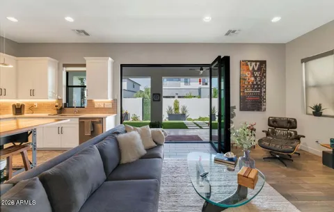 a living room with furniture and large windows