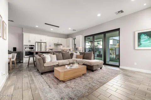 a living room with furniture and kitchen view