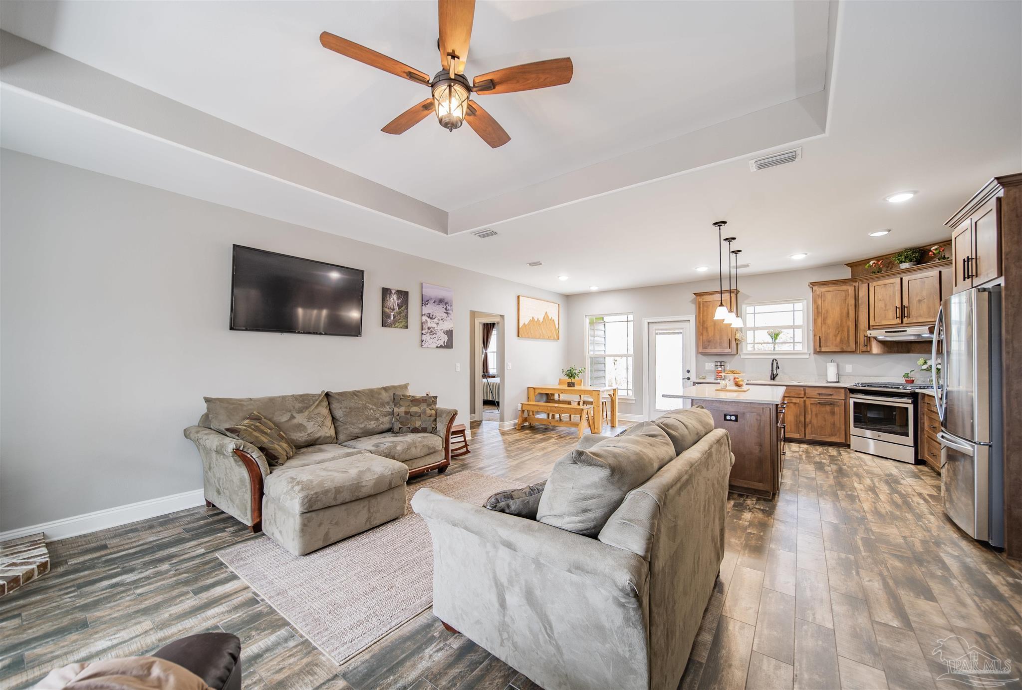 2800 Dunsford Road Jay, FL 32565 - Photo 11 of 42 a living room with furniture kitchen view and a flat screen tv