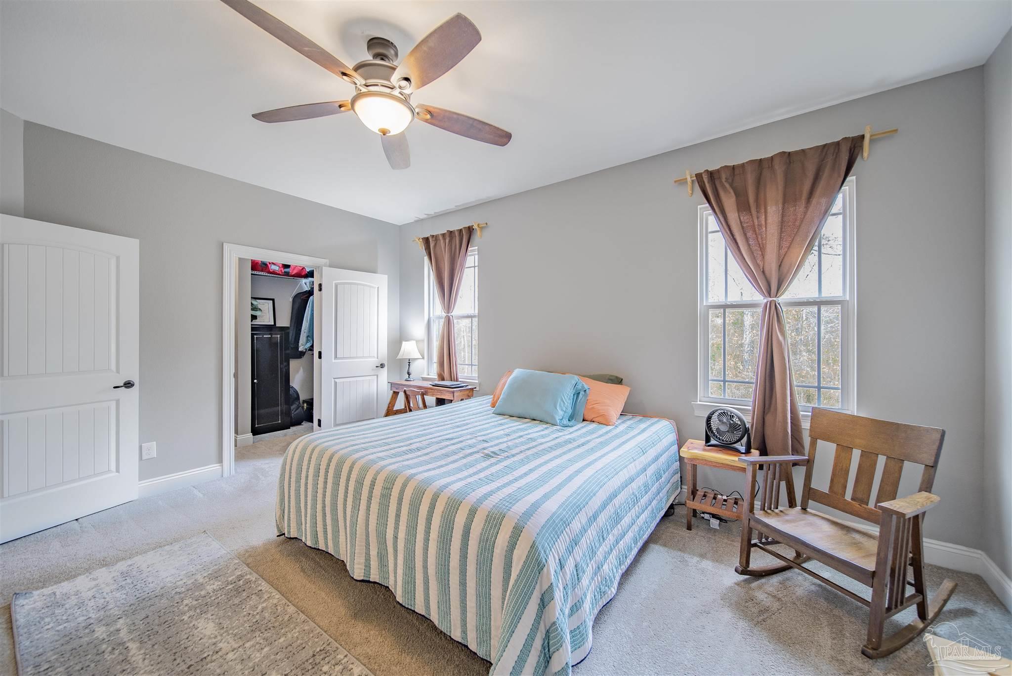 2800 Dunsford Road Jay, FL 32565 - Photo 13 of 42 a bedroom with a bed a chandelier and a book shelf