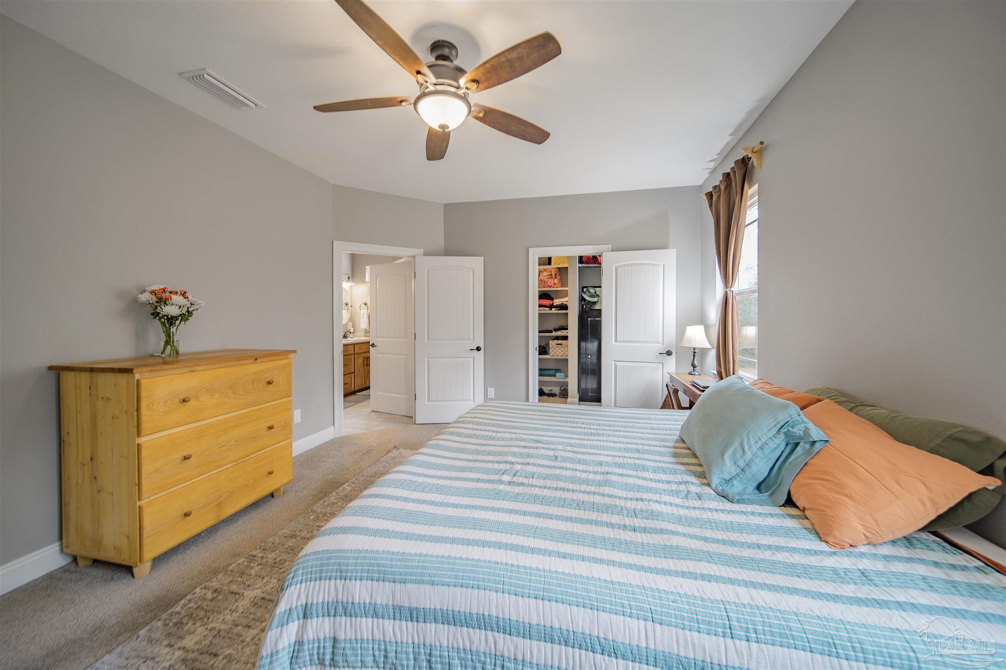 2800 Dunsford Road Jay, FL 32565 - Photo 14 of 42 a bedroom with a bed and a chandelier