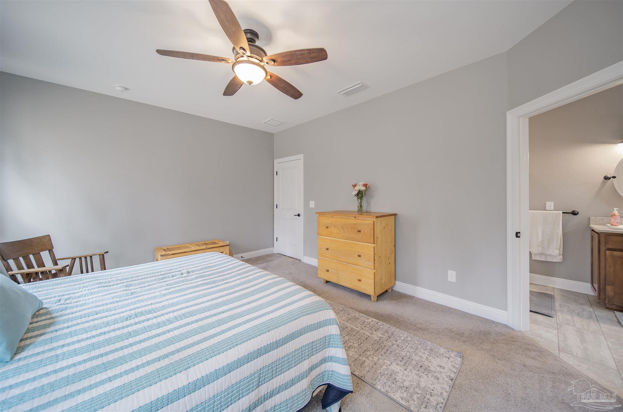 2800 Dunsford Road Jay, FL 32565 - Photo 15 of 42 a bedroom with a bed and a chandelier