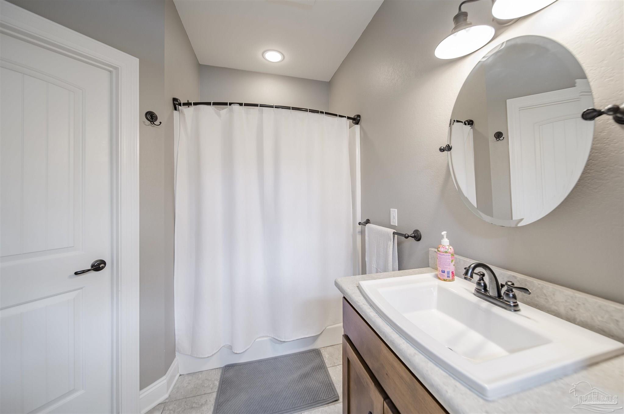 2800 Dunsford Road Jay, FL 32565 - Photo 17 of 42 a bathroom with a sink vanity and a mirror