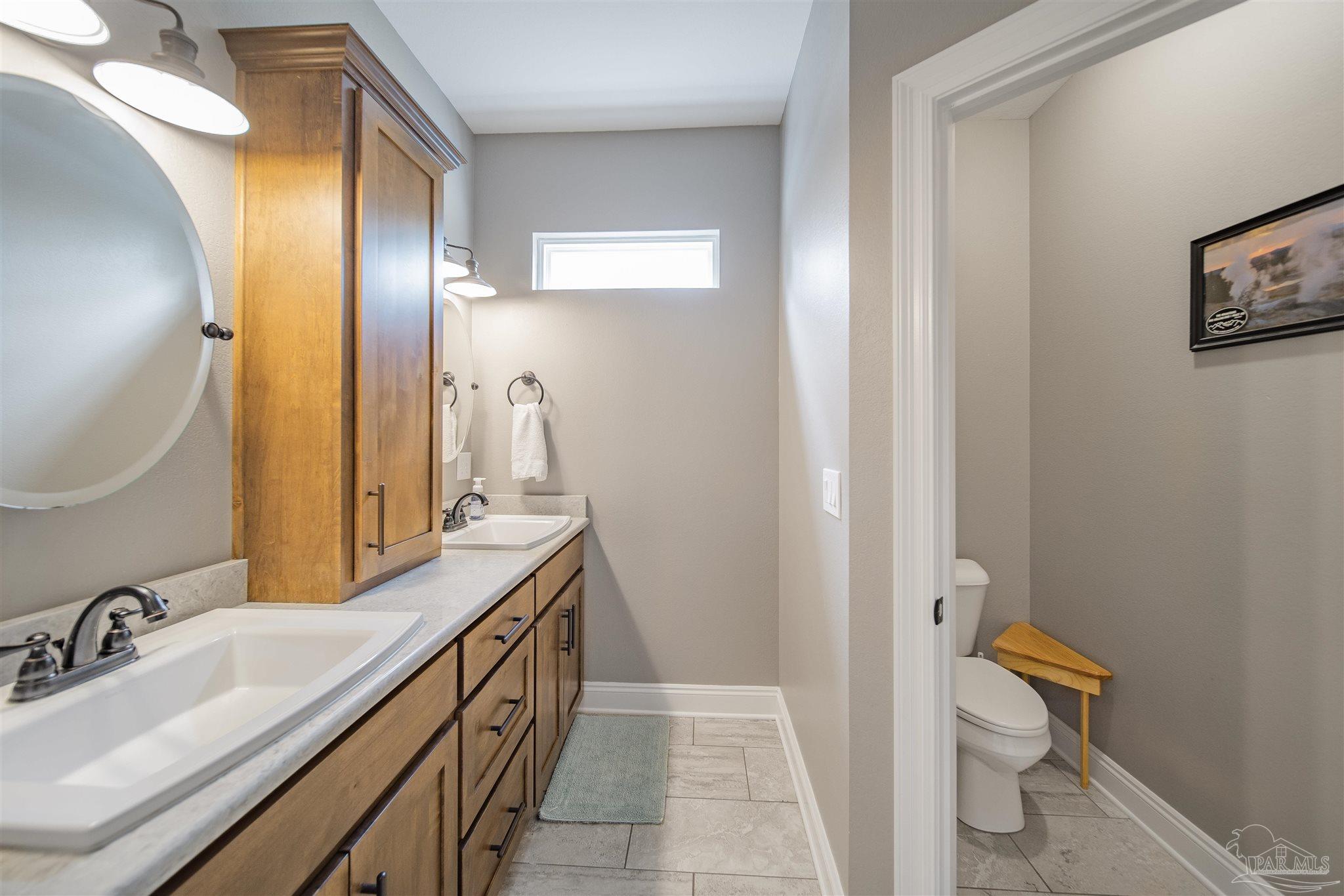2800 Dunsford Road Jay, FL 32565 - Photo 18 of 42 a bathroom with a sink a toilet and a mirror
