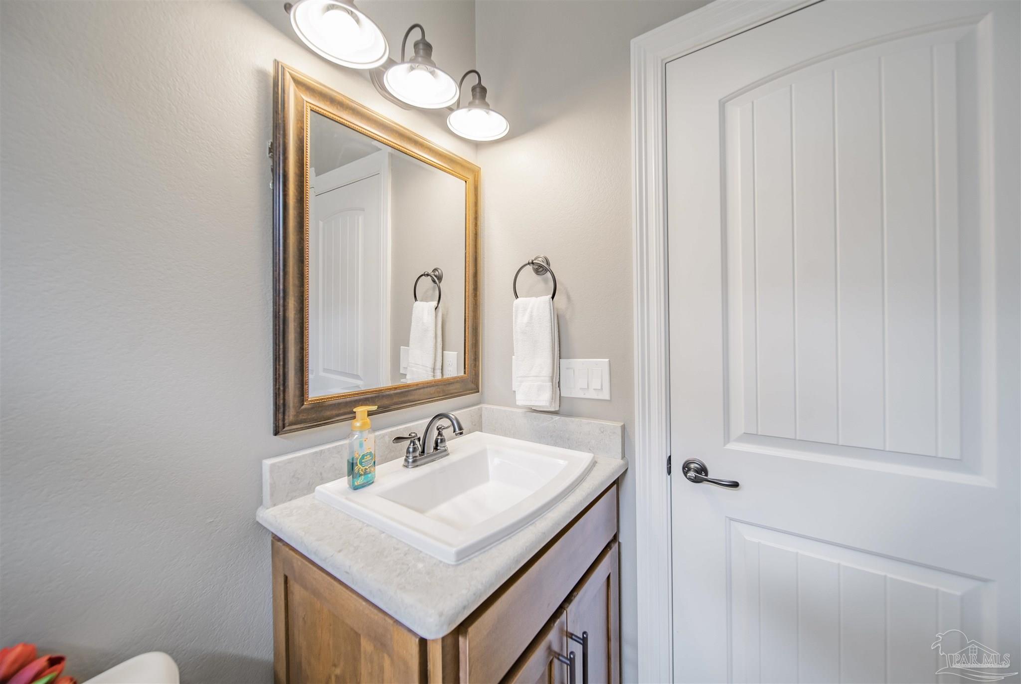 2800 Dunsford Road Jay, FL 32565 - Photo 23 of 42 a bathroom with a sink a mirror and a vanity