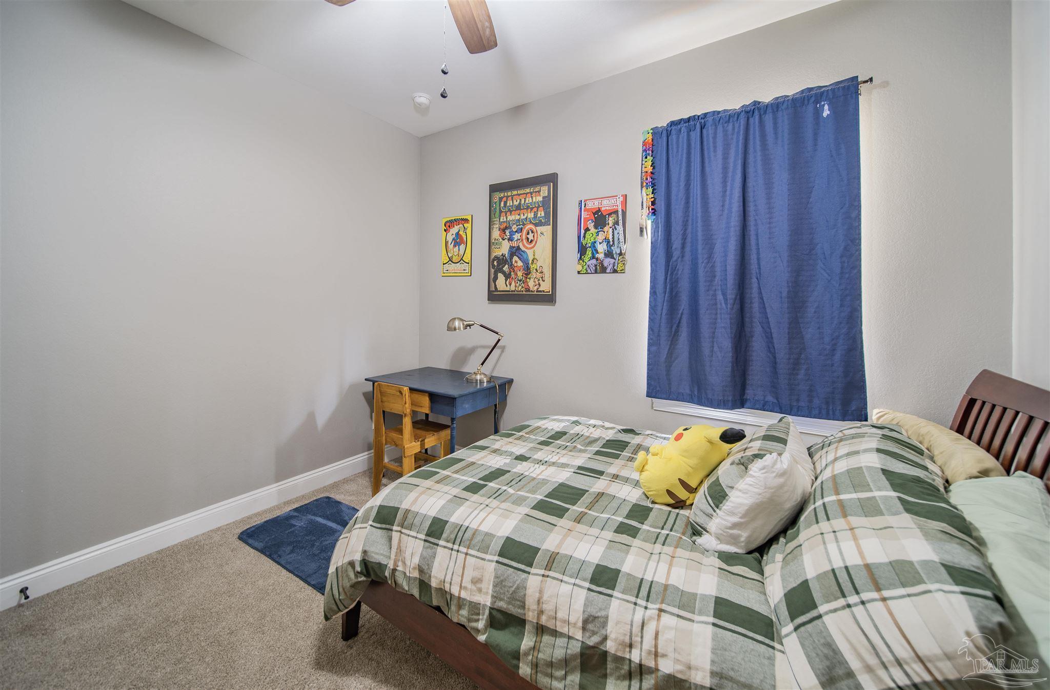 2800 Dunsford Road Jay, FL 32565 - Photo 25 of 42 a bedroom with a bed a table and chair