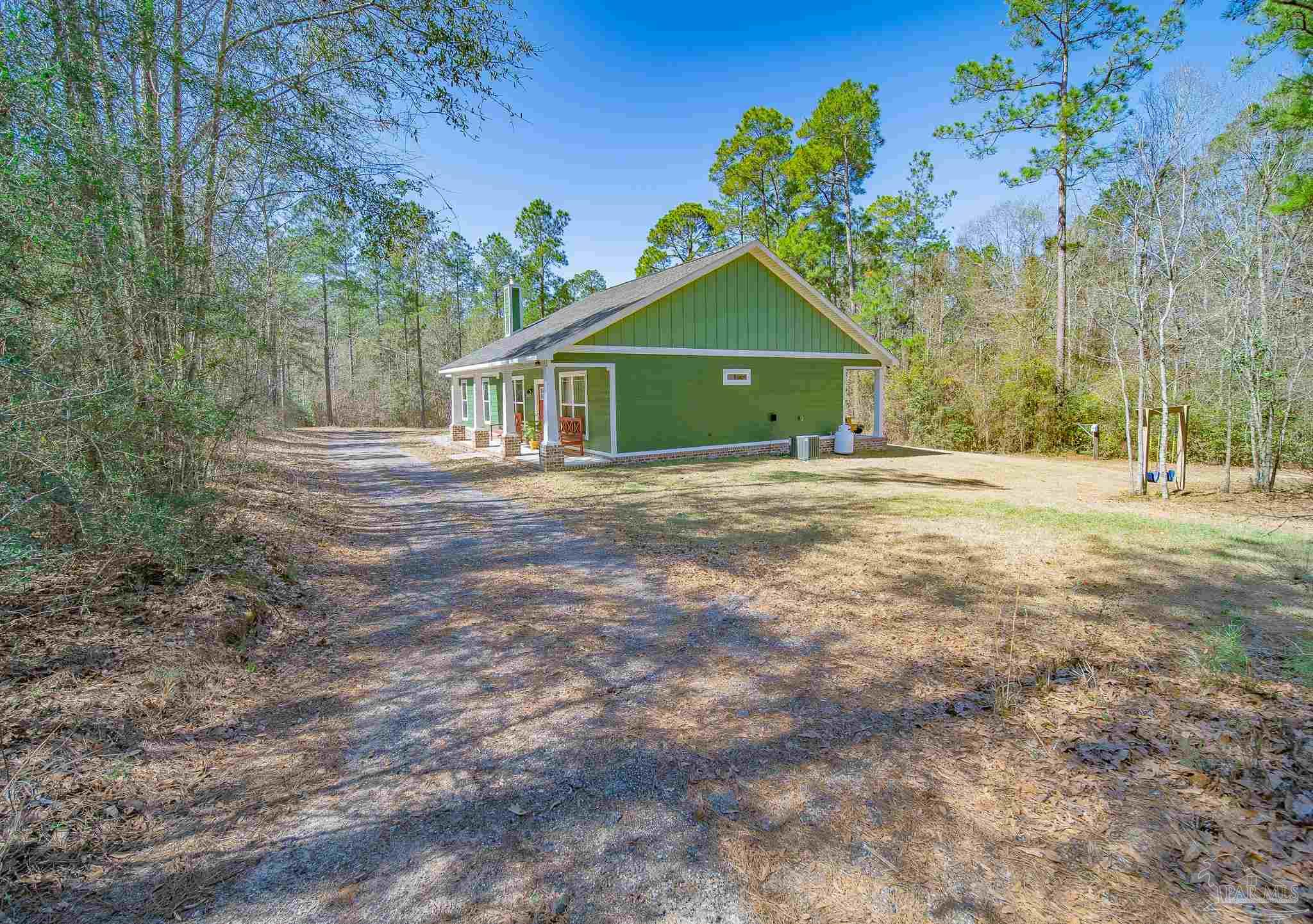 2800 Dunsford Road Jay, FL 32565 - Photo 26 of 42 a front view of a house with a yard and garage
