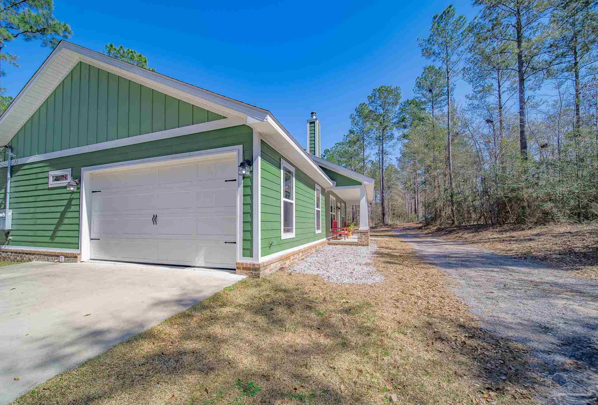 2800 Dunsford Road Jay, FL 32565 - Photo 27 of 42 a front view of a house with a yard and garage